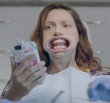Woman at the dentist looking at her phone